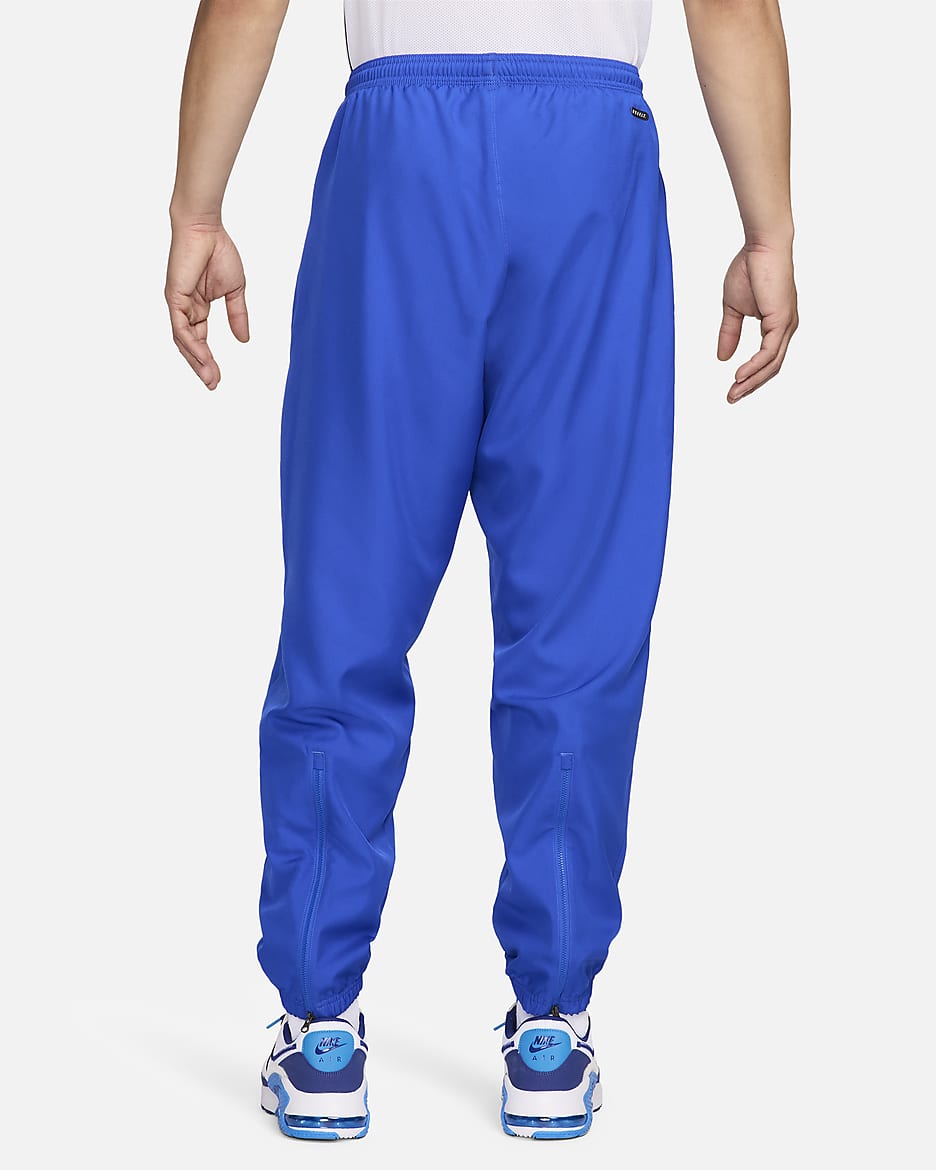 Blue nike track pants sale